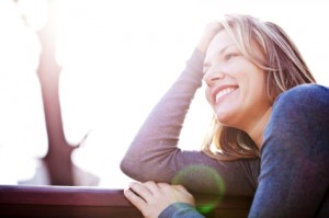 Portrait of beautiful woman leaned on the bench.